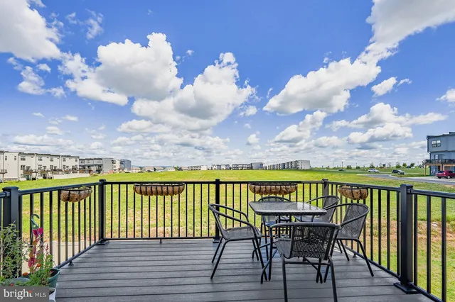 a view of a roof deck with furniture