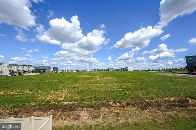 a view of a big yard with lots of green space