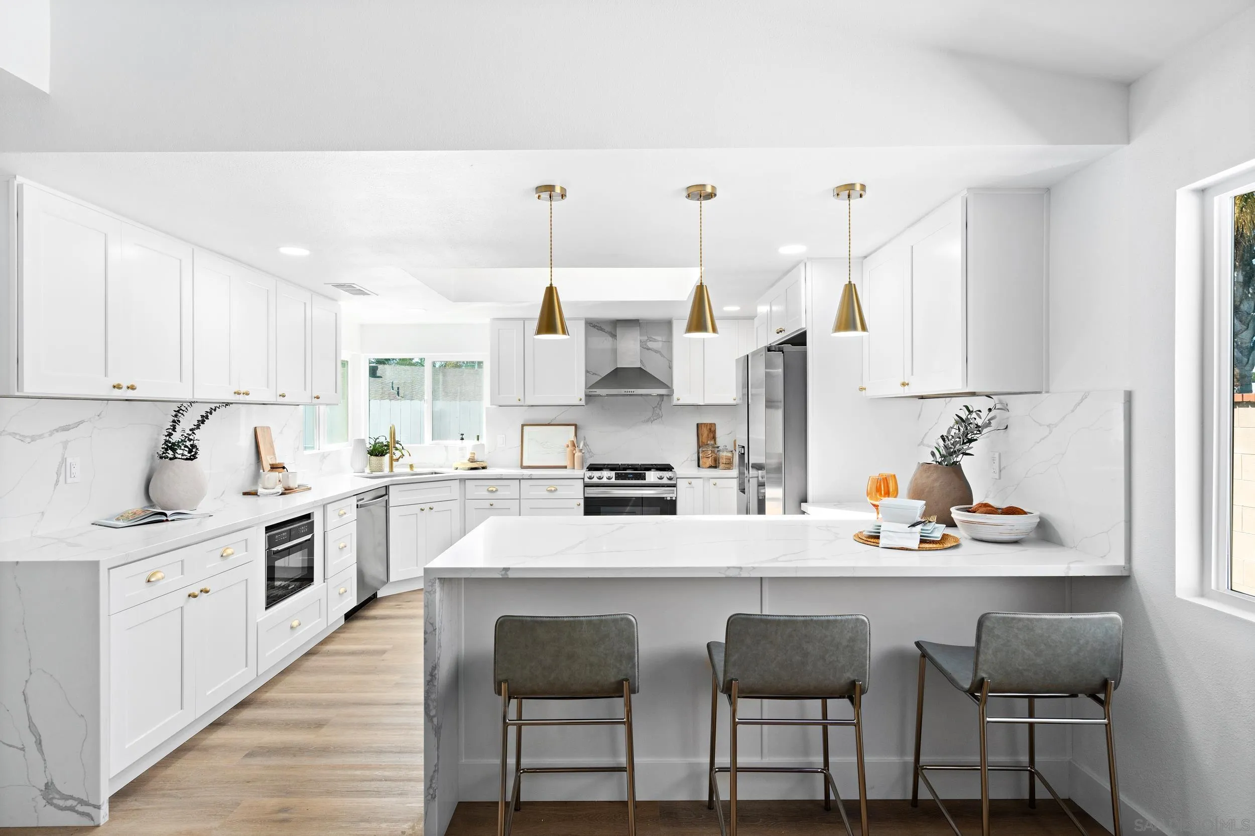 1621 Downs Street Oceanside, CA 92054 - Photo 16 of 38 a kitchen with stainless steel appliances kitchen island granite countertop a table chairs sink and cabinets