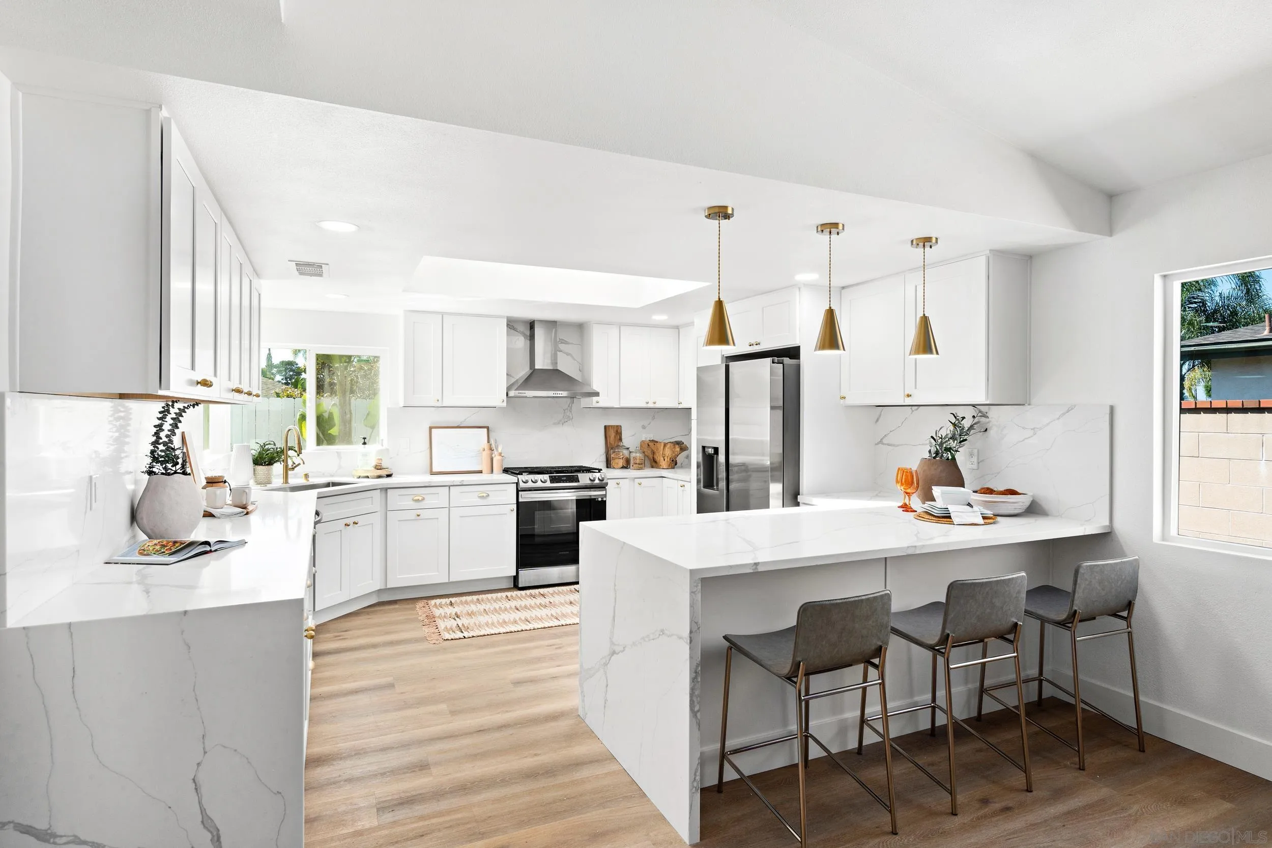 1621 Downs Street Oceanside, CA 92054 - Photo 17 of 38 a kitchen with white cabinets and stove