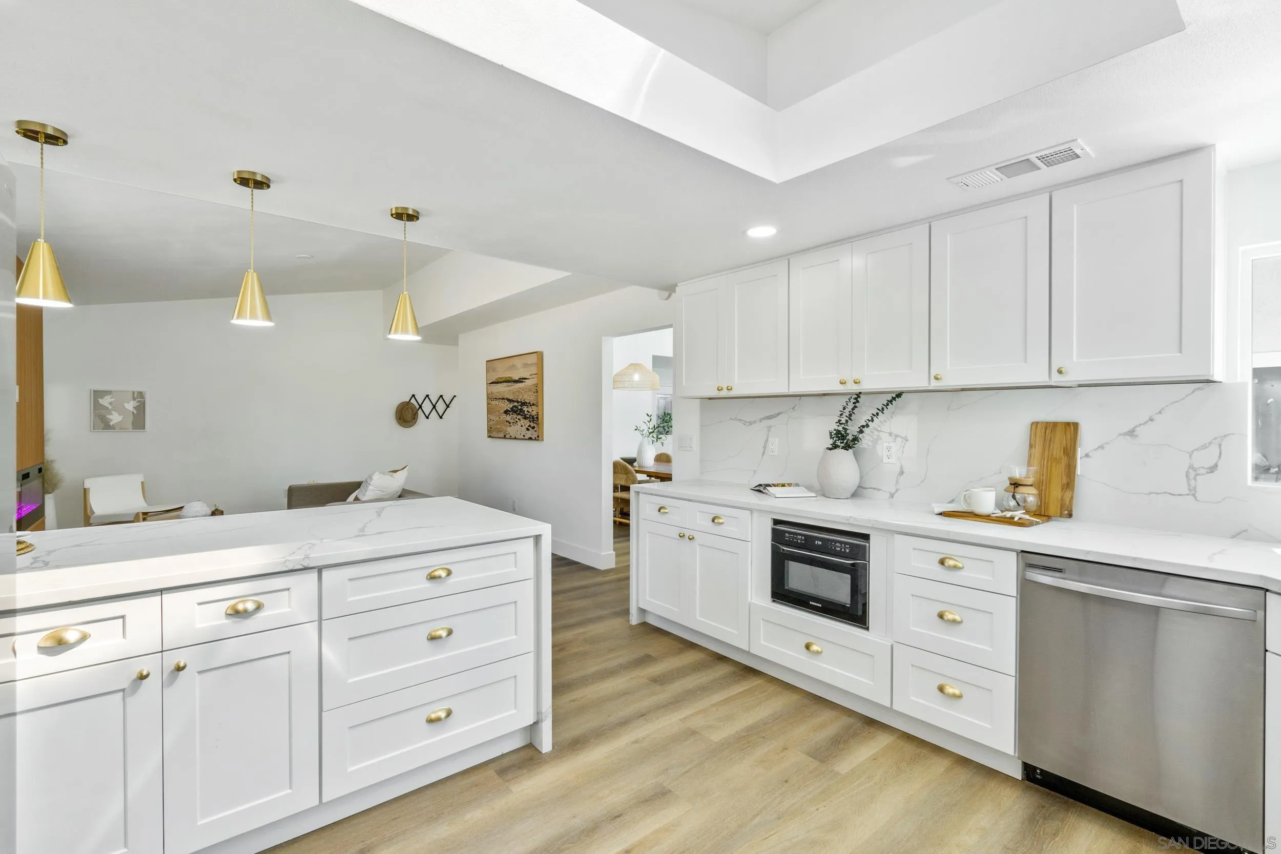 1621 Downs Street Oceanside, CA 92054 - Photo 18 of 38 a kitchen with white cabinets and white appliances