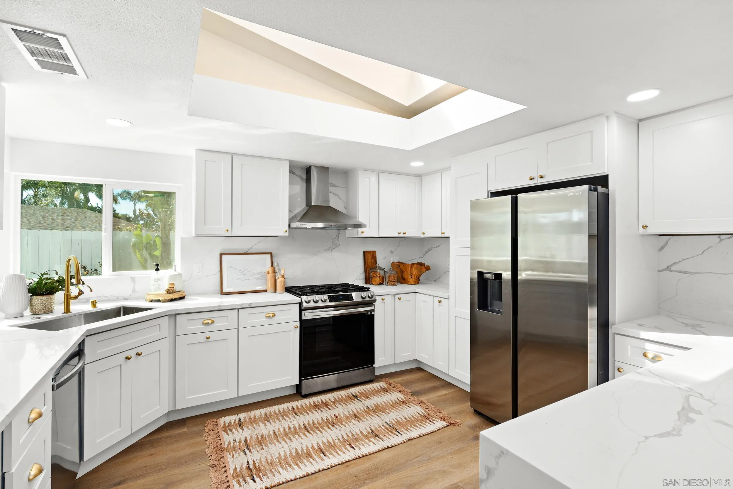 1621 Downs Street Oceanside, CA 92054 - Photo 19 of 38 a kitchen with stainless steel appliances granite countertop a refrigerator sink and stove