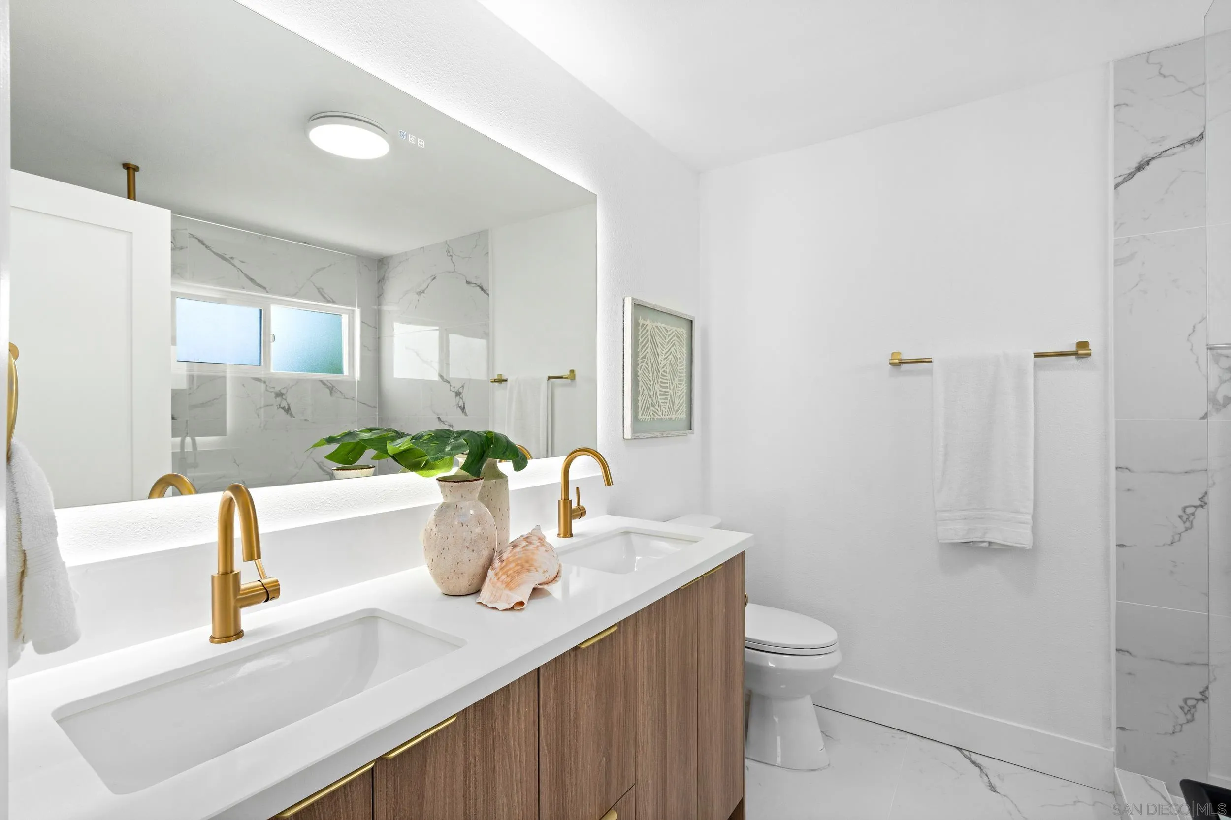 1621 Downs Street Oceanside, CA 92054 - Photo 25 of 38 a bathroom with a granite countertop sink a toilet a mirror and shower