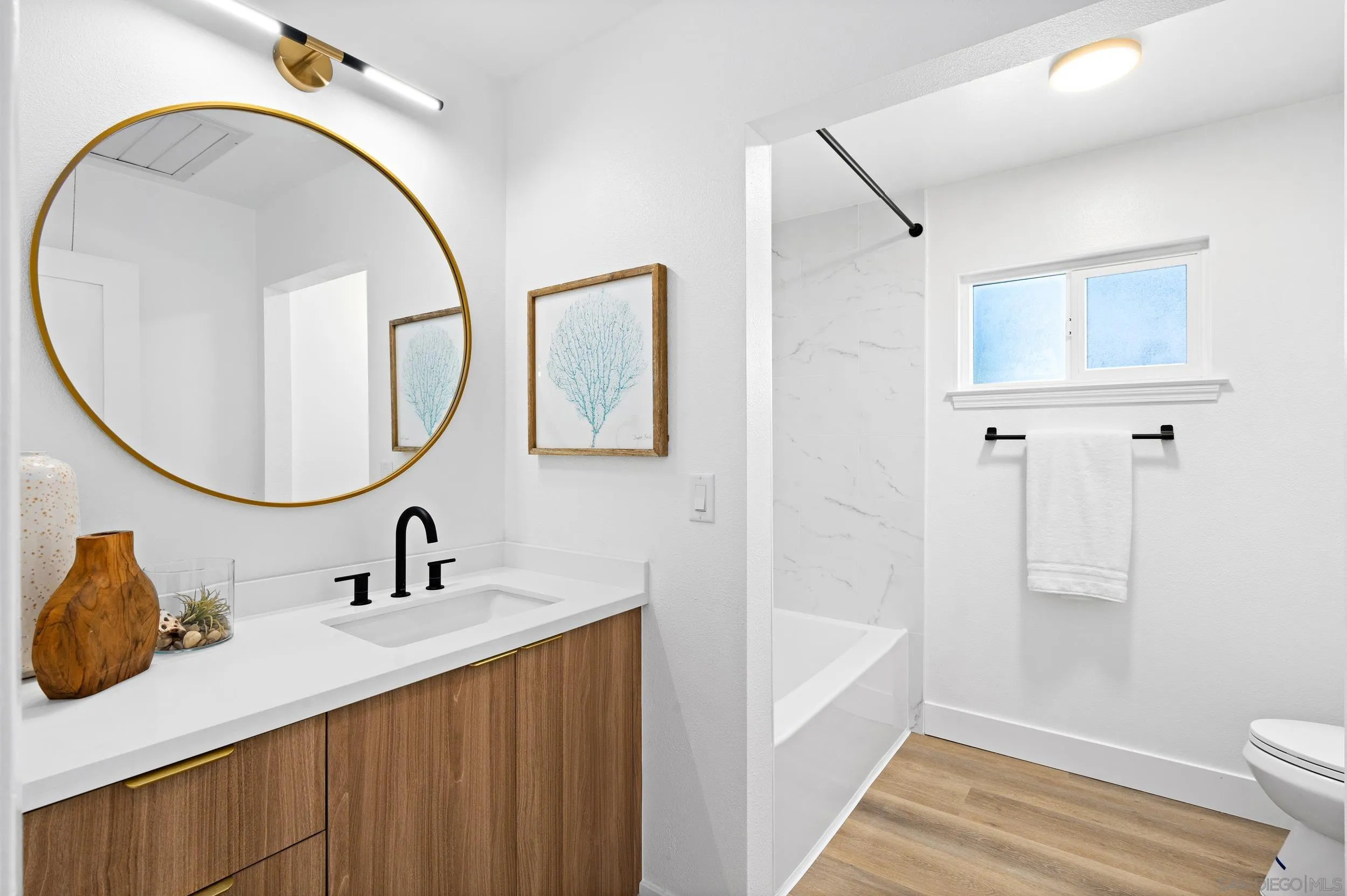 1621 Downs Street Oceanside, CA 92054 - Photo 10 of 38 a bathroom with a sink and a mirror