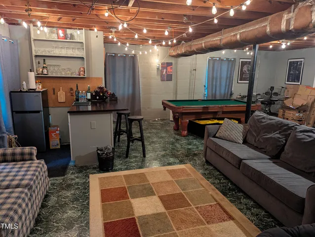 a living room with lots of furniture and a chandelier