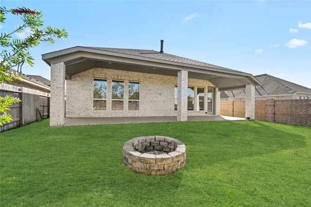 a view of a house with a backyard