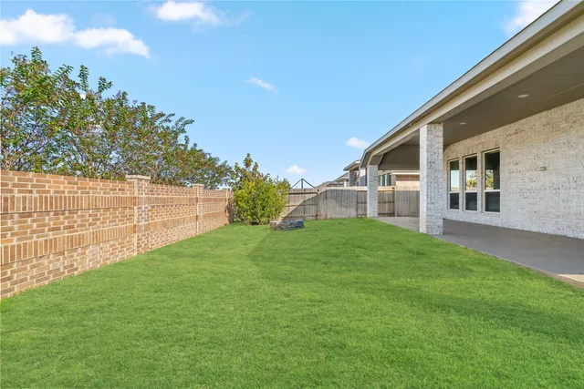 a view of a backyard with plants and a garden