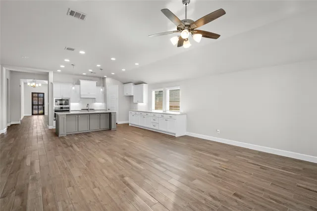 a view of an empty room with a kitchen