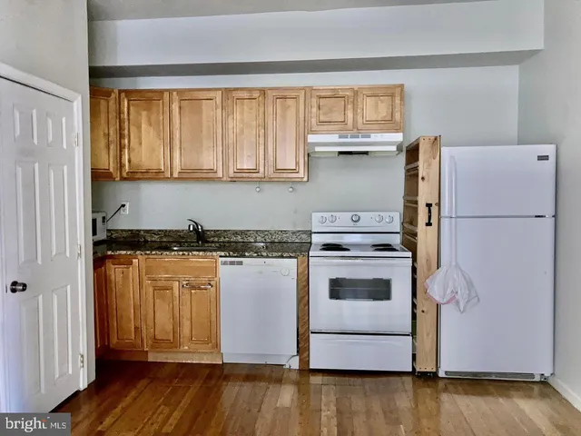 a kitchen with a refrigerator and a stove