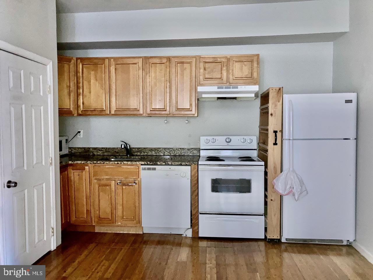 a kitchen with a refrigerator and a stove