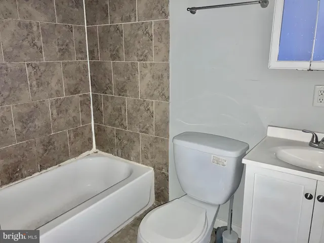 a bathroom with a toilet a sink and bathtub