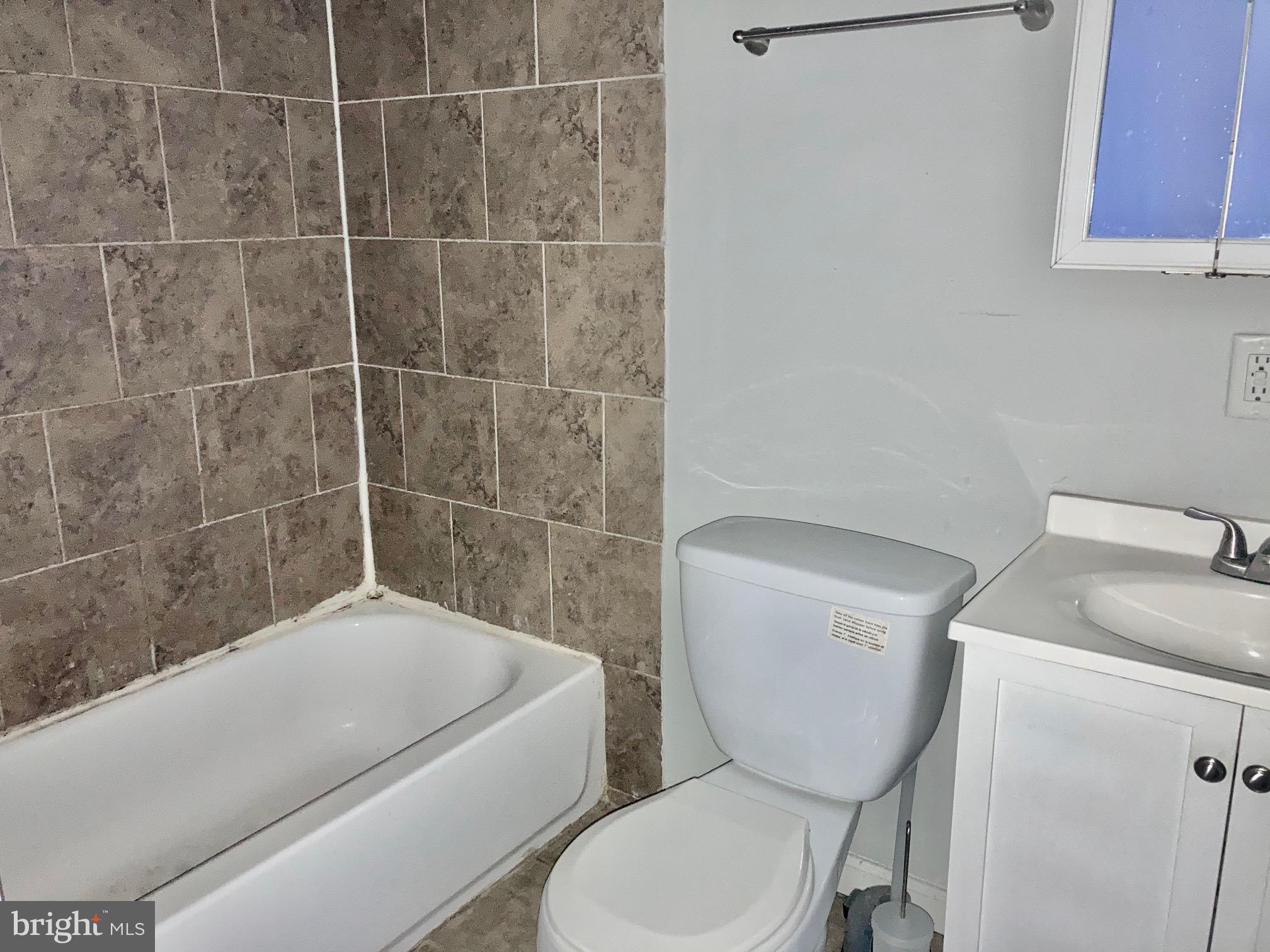 4825 Baltimore Avenue, Unit 4 Philadelphia, PA 19143 - Photo 6 of 10 a bathroom with a toilet a sink and bathtub