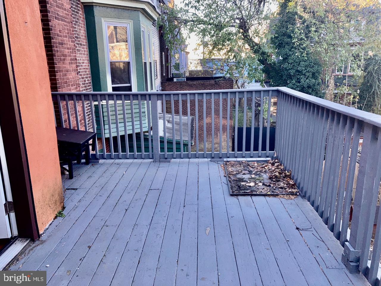4825 Baltimore Avenue, Unit 4 Philadelphia, PA 19143 - Photo 8 of 10 a view of deck with wooden floor and fence