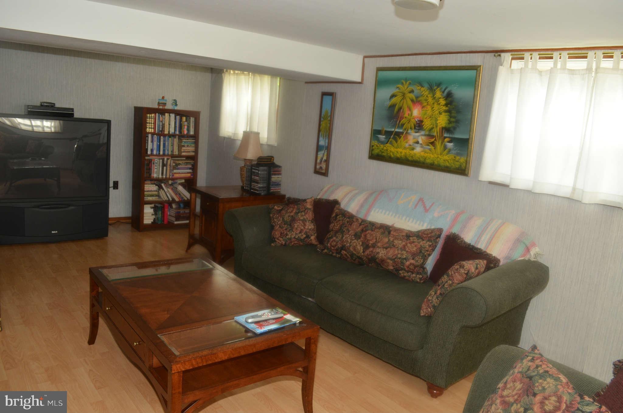 1503 Adamsview Road Baltimore, MD 21228 - Photo 22 of 26 a living room with furniture and a flat screen tv