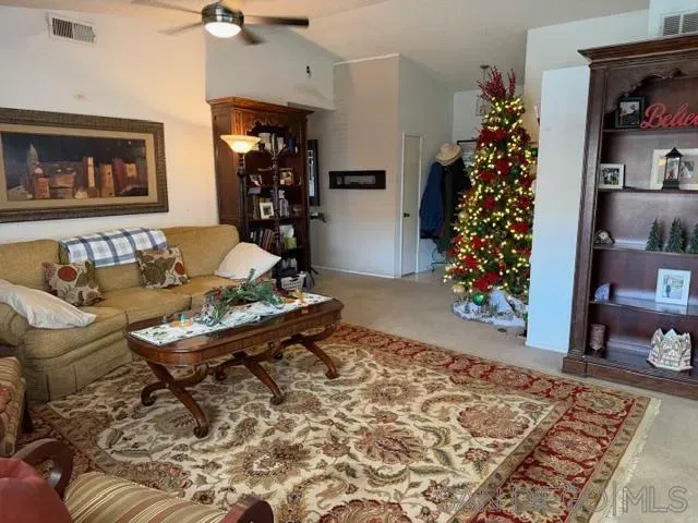 a living room with furniture and a potted plant
