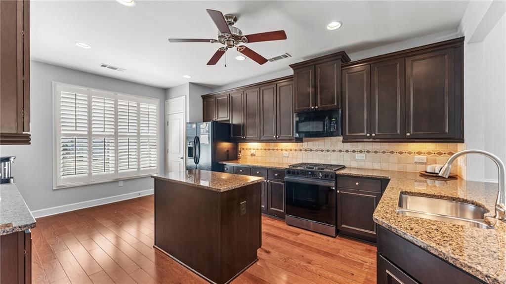 3418 Locust Cove Road Gainesville, GA 30504 - Photo 6 of 61 a kitchen with stainless steel appliances granite countertop a sink stove and refrigerator