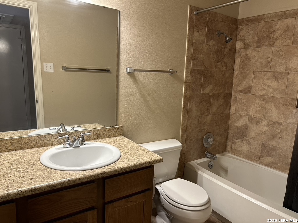 13018 Heimer Road, Unit 710 San Antonio, TX 78216 - Photo 18 of 27 a bathroom with a sink toilet and shower