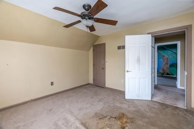 a view of room with a ceiling fan and window