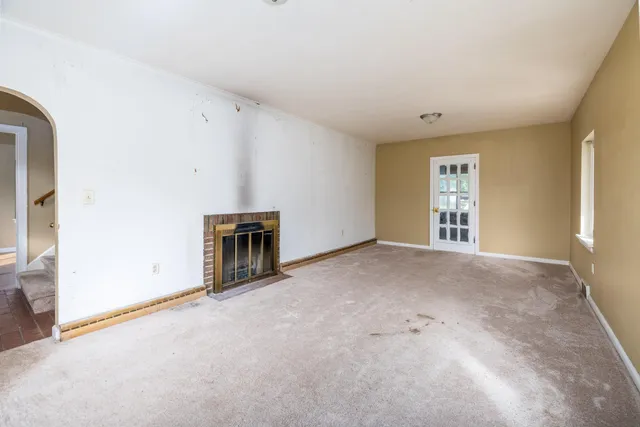 a view of an empty room with a fireplace