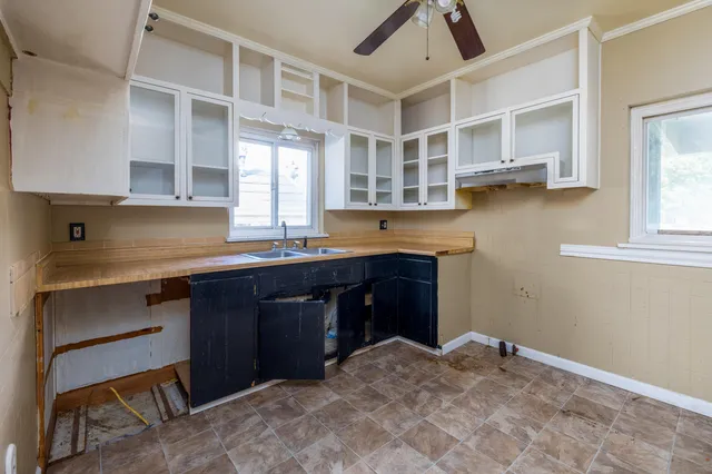 a kitchen with a sink cabinets and window