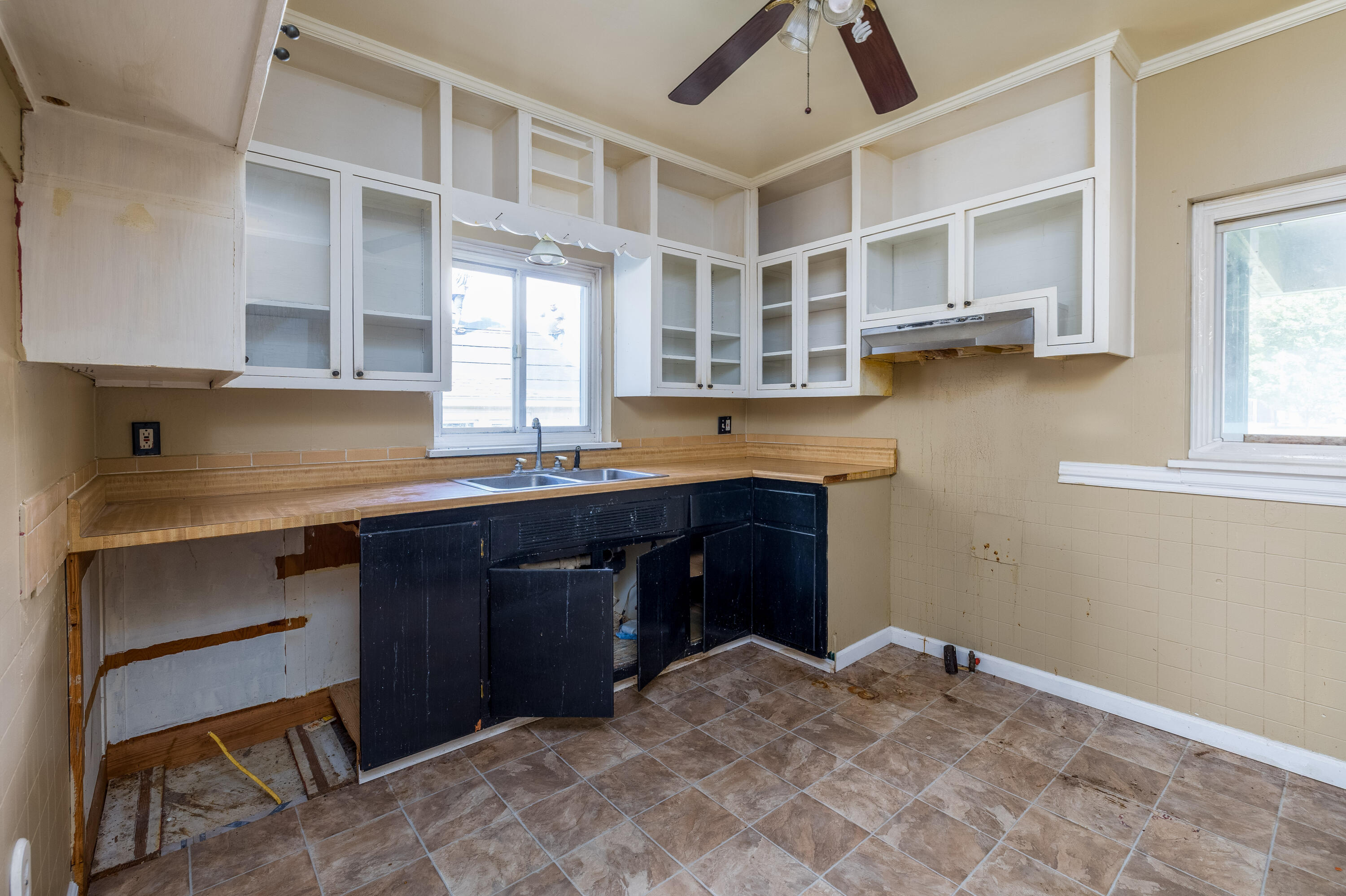 106 West Washington Street Kentland, IN 47951 - Photo 9 of 31 a kitchen with a sink cabinets and window