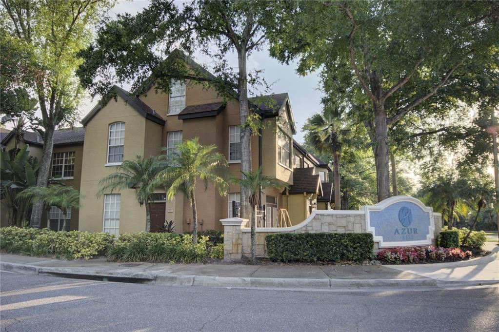 6300 Raleigh Street, Unit 102 Orlando, FL 32835 - Photo 1 of 1 a front view of a house with a garden and trees