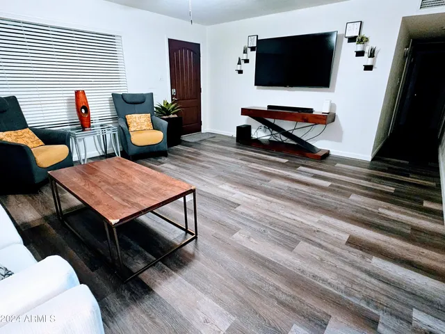 a bedroom with a bed and dresser with mirror