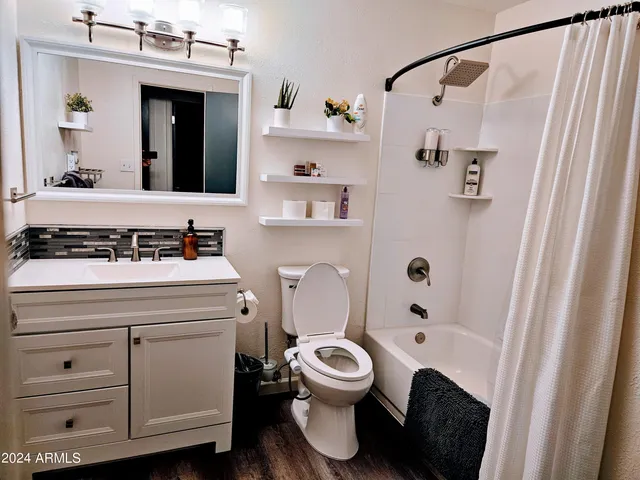 a bedroom with a bed a rug and a large mirror