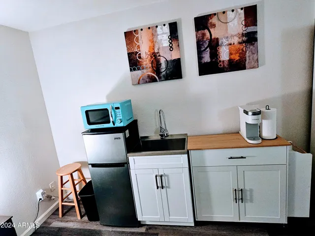a bedroom with bed and a chandelier
