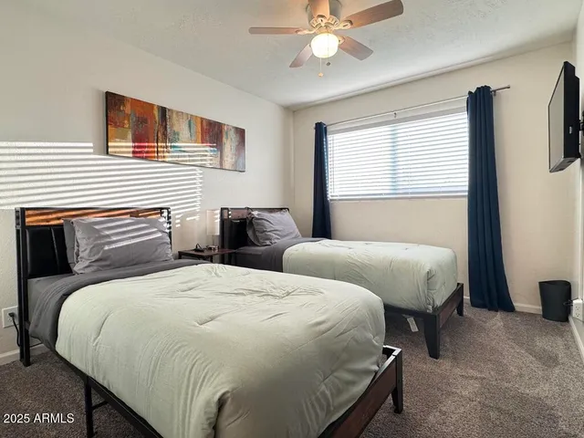 a dining room with wooden floor a chandelier a glass table and chairs