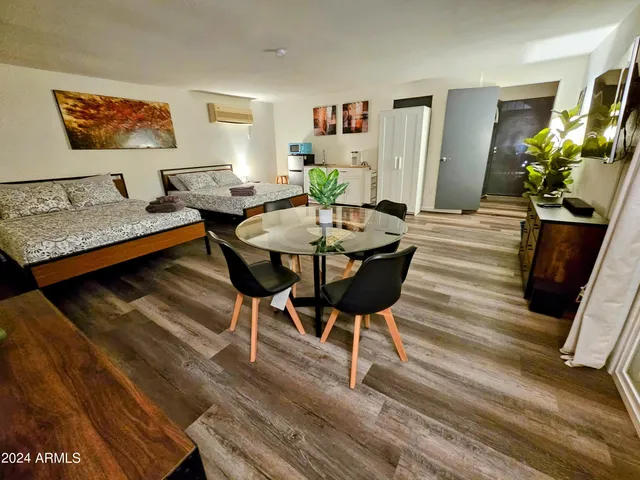 a view of a dining room with furniture wooden floor and chandelier