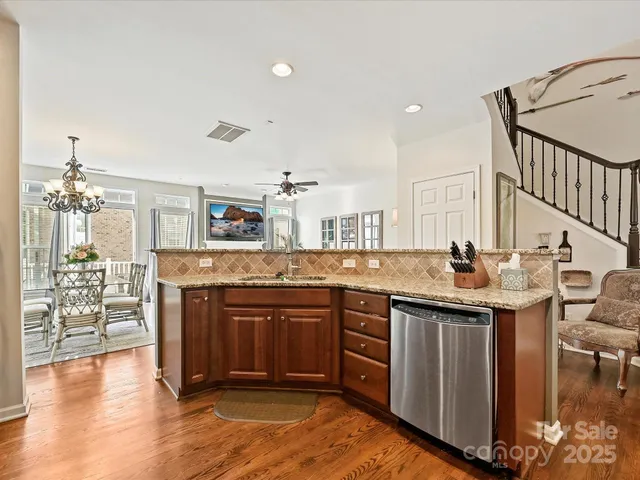 a kitchen with stainless steel appliances granite countertop a stove and cabinets