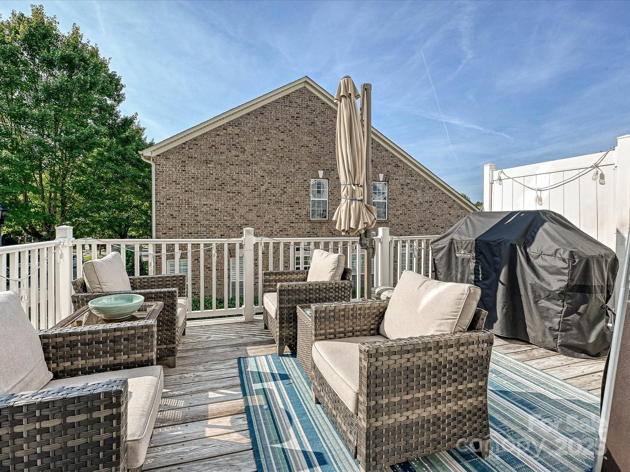 405 Armour Street Davidson, NC 28036 - Photo 14 of 33 a balcony view with couches and wooden floor