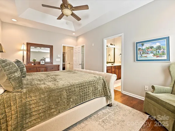 a bed sitting in a spacious bedroom next to a window