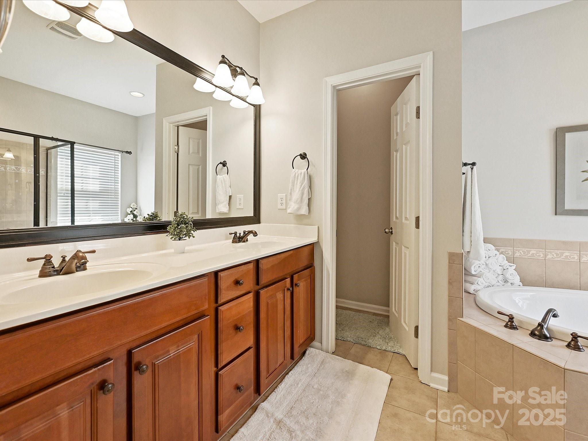 405 Armour Street Davidson, NC 28036 - Photo 22 of 33 a spacious bathroom with a double vanity sink mirror double and shower