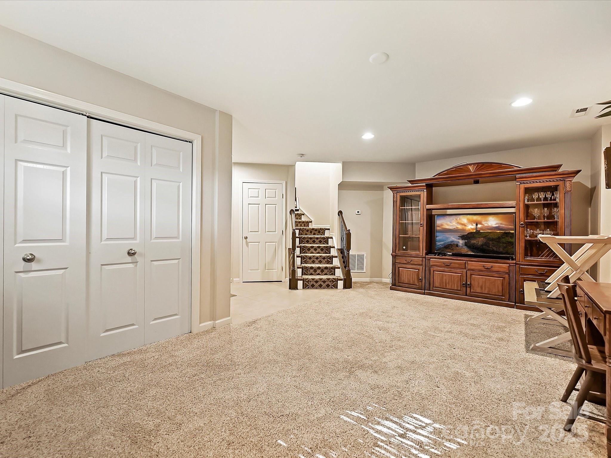 405 Armour Street Davidson, NC 28036 - Photo 29 of 33 a view of an empty room with furniture and a ceiling fan