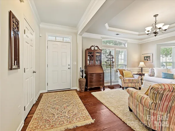 a bedroom with furniture and wooden floor