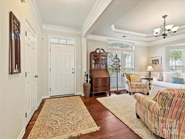 a bedroom with furniture and wooden floor