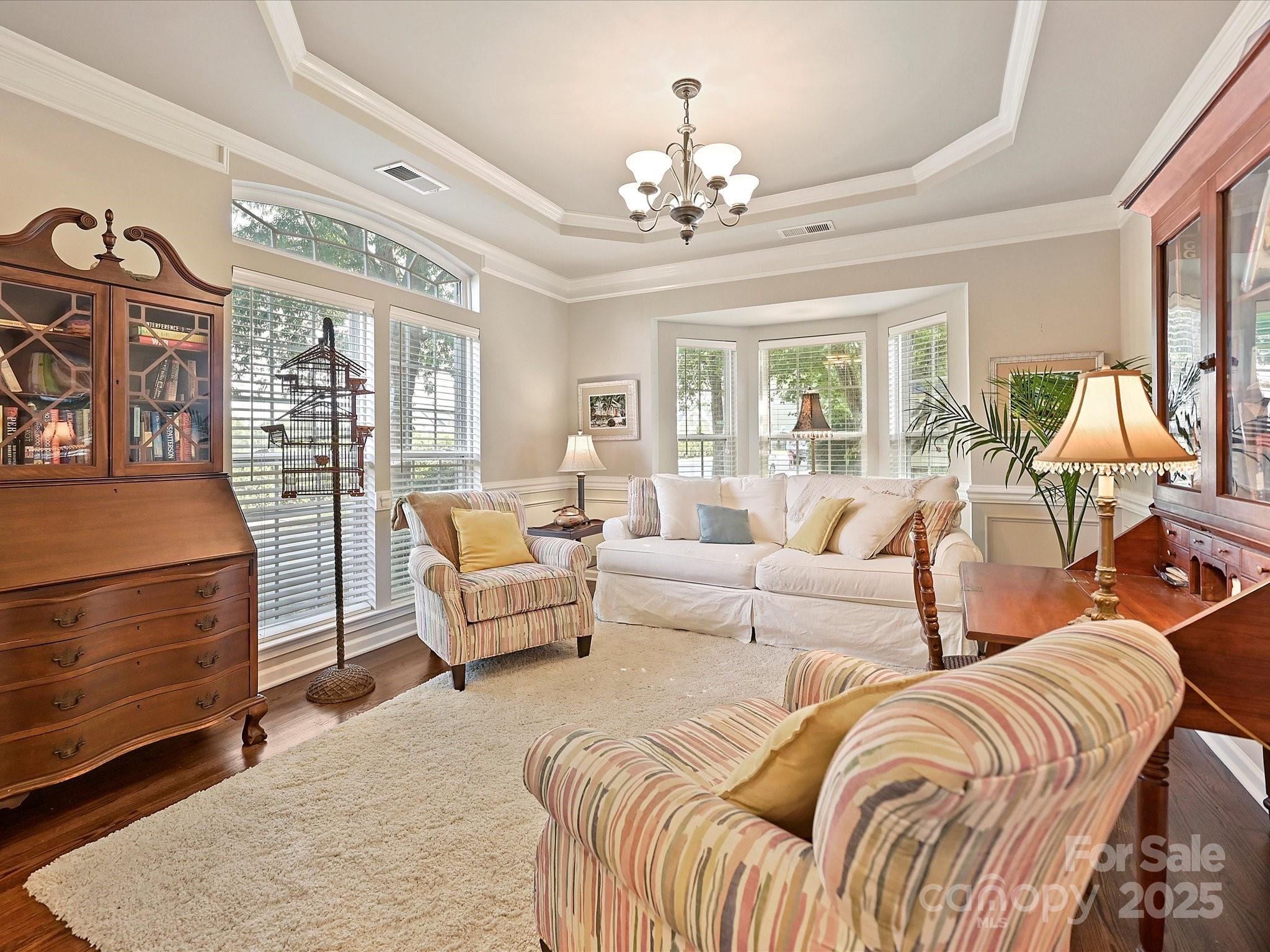 405 Armour Street Davidson, NC 28036 - Photo 4 of 33 a living room with furniture and a chandelier