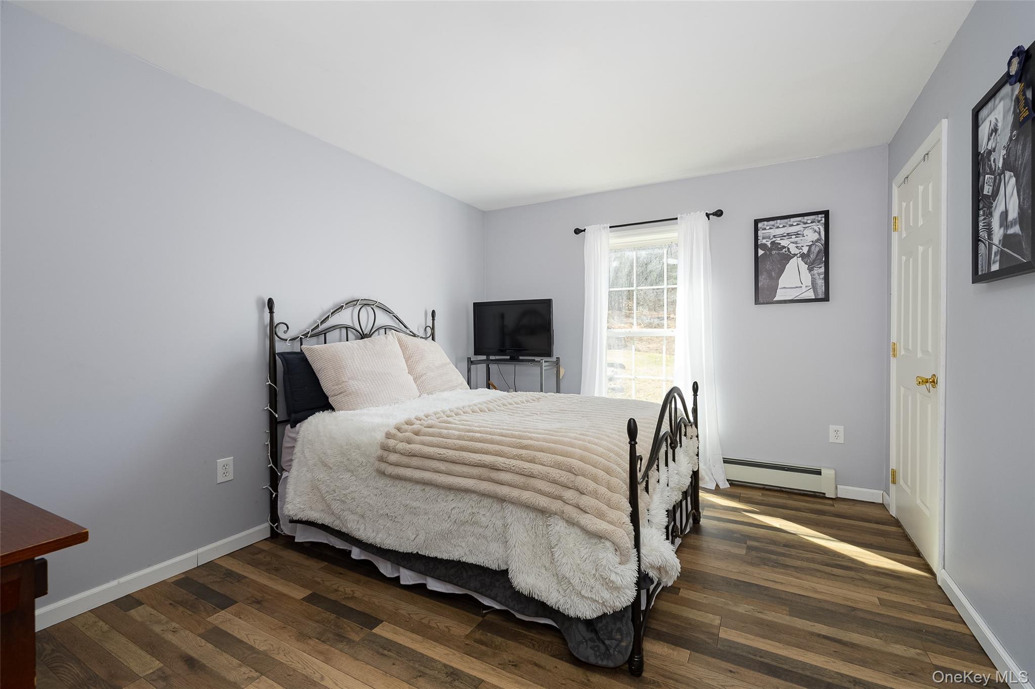 279 Milewood Road Millbrook, NY 12545 - Photo 13 of 33 a bedroom with a bed and wooden floor