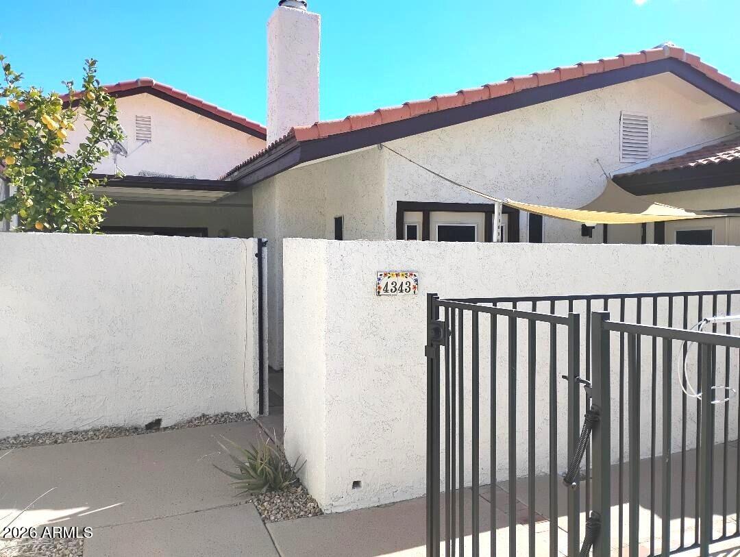 4343 East Osborn Road Phoenix, AZ 85018 - Photo 29 of 41 a view of a house with a backyard