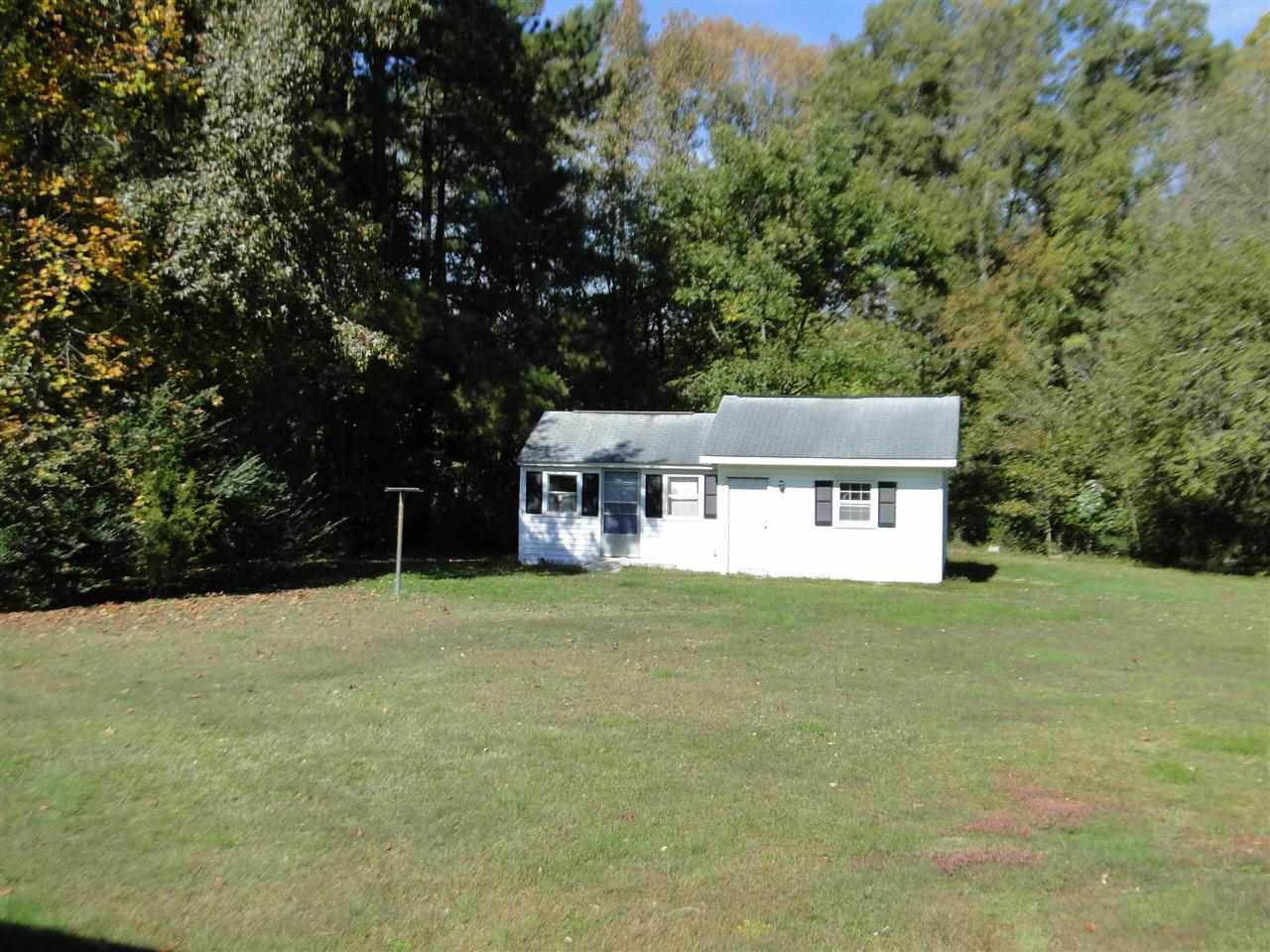3911 Cheek Road Durham, NC 27704 - Photo 17 of 17 a house that has a tree in it