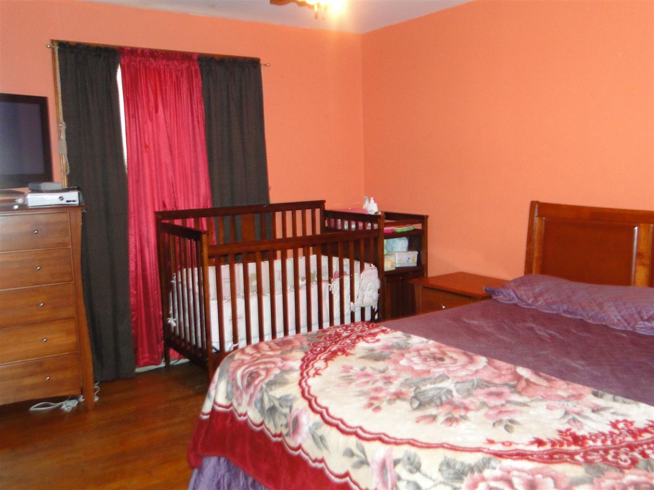 3911 Cheek Road Durham, NC 27704 - Photo 4 of 17 a bed sitting in a bedroom next to a window
