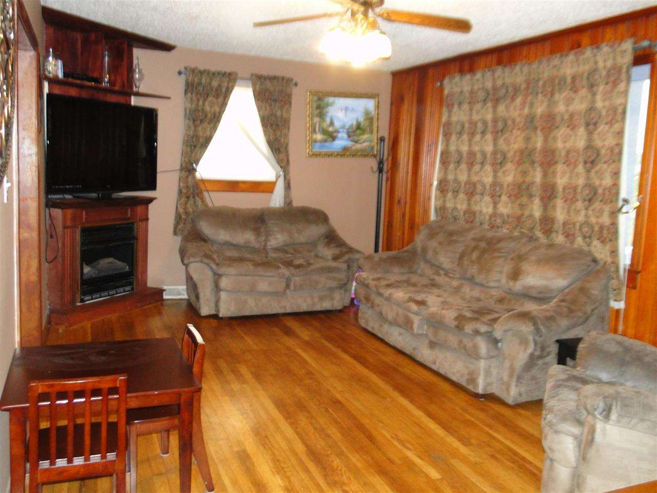 3911 Cheek Road Durham, NC 27704 - Photo 10 of 17 a living room with furniture and a flat screen tv