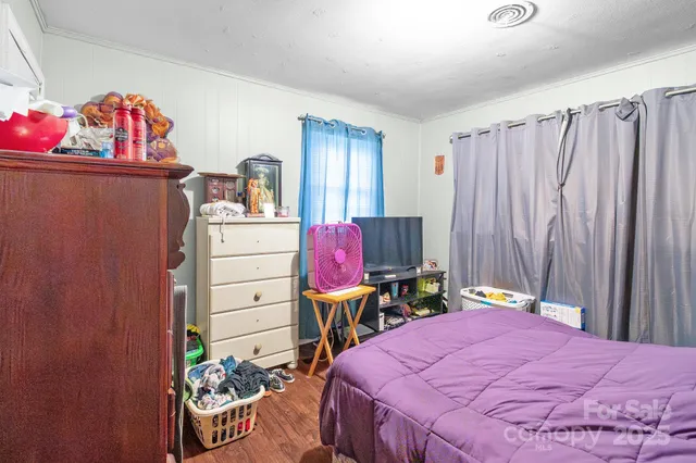 a bedroom with a bed and a dresser in it