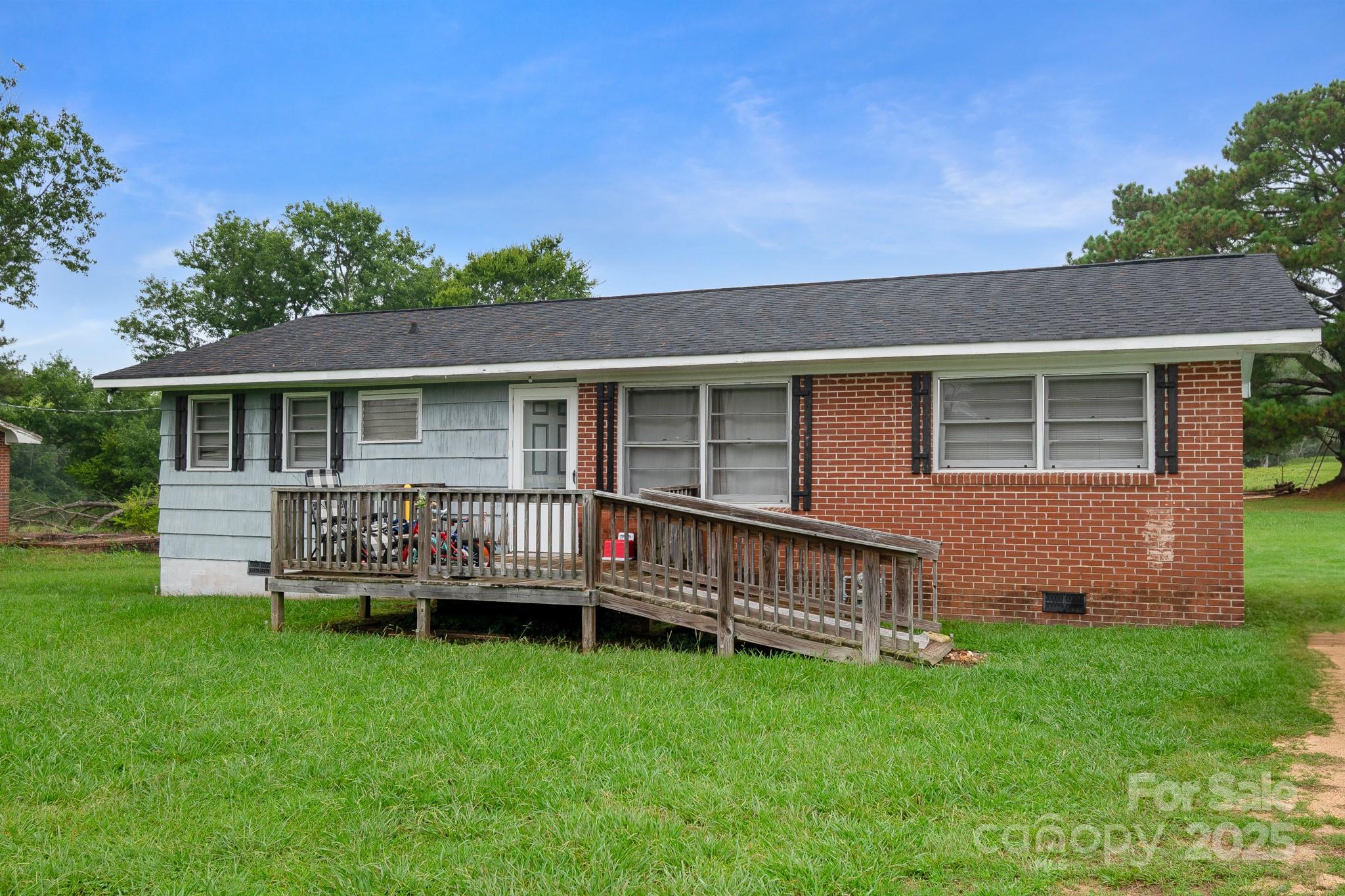 940 West End Road Chester, SC 29706 - Photo 2 of 16 a backyard of a house with wooden deck and outdoor seating