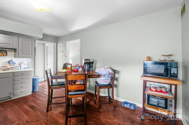 a dining room with furniture a rug and wooden floor