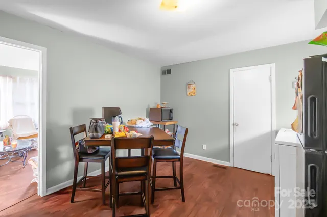 a dining room with furniture and a floor to ceiling window