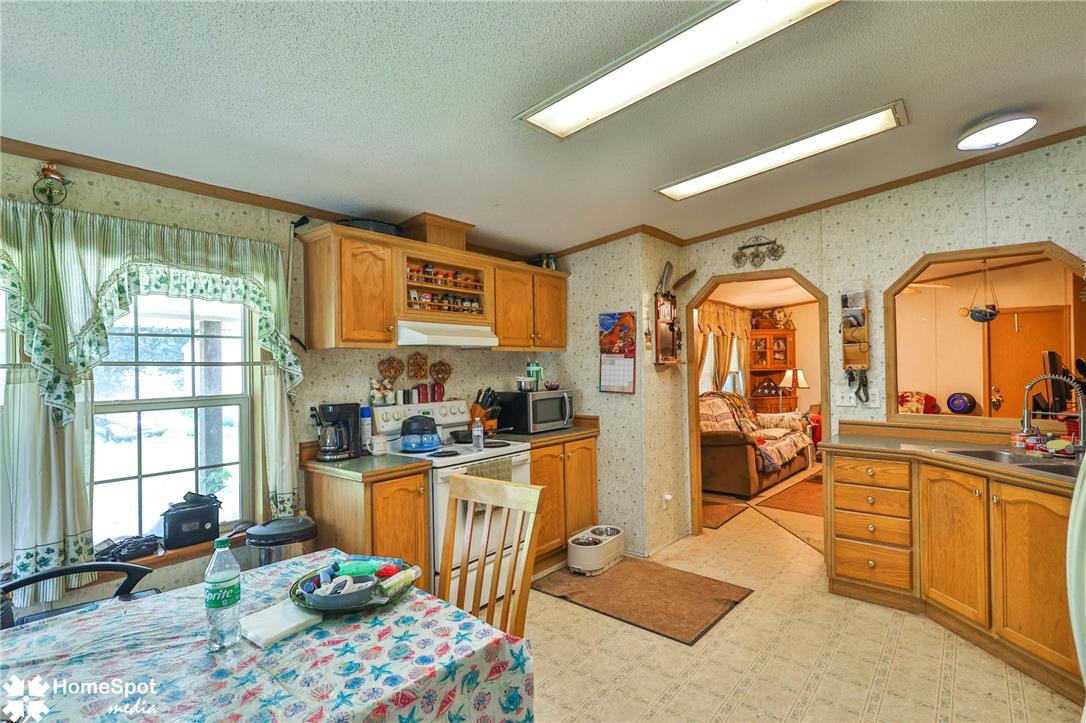 3795 Rhoades Road Kempton, PA 19529 - Photo 30 of 42 A cheerful kitchen space features a sink and counter, providing a view into the adjacent living area.