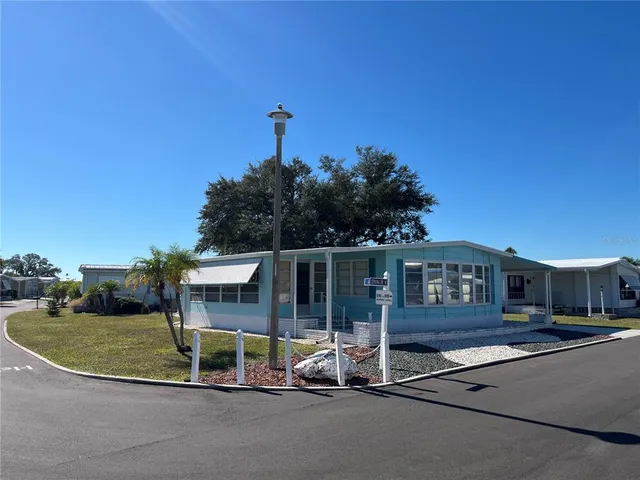 a view of a house with backyard and porch
